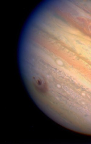 True-colour image of Jupiter, showing impact zones
