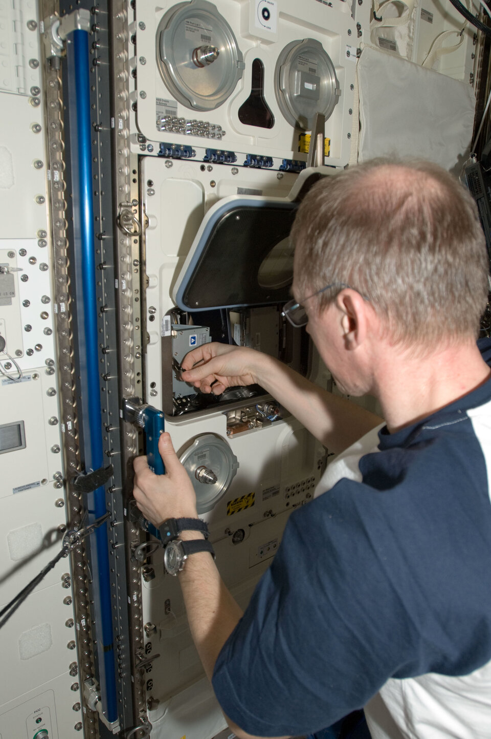 ESA's first Space Station commander Frank de Winne working on yeast experiment