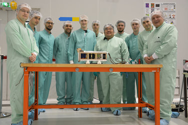 The Fly Your Satellite delegation in front of the P-POD 