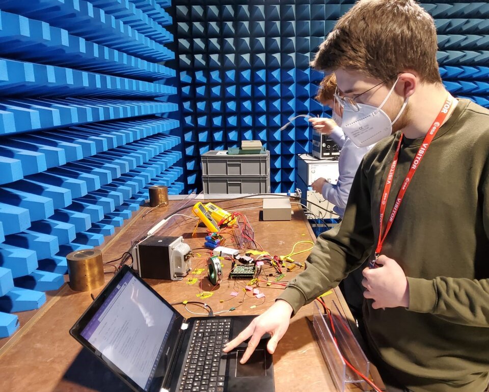 A student from the university of Stuttgart working on the PCDU test setup.