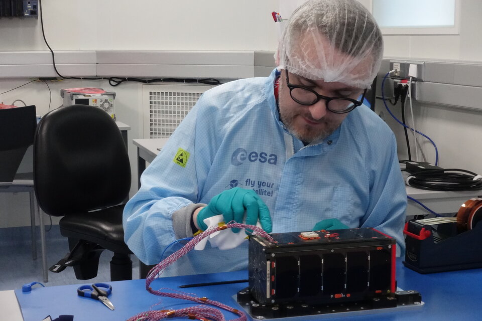 Team member performing functional tests on the satellite