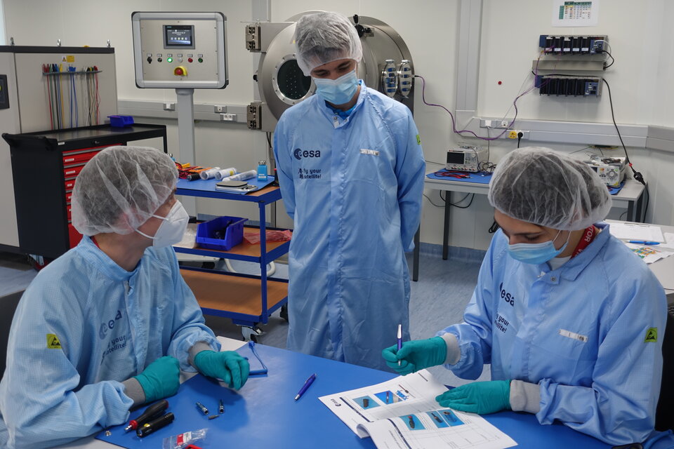 University students working with a trainer in the CubeSat Support Facility in ESA ESEC, Belgium
