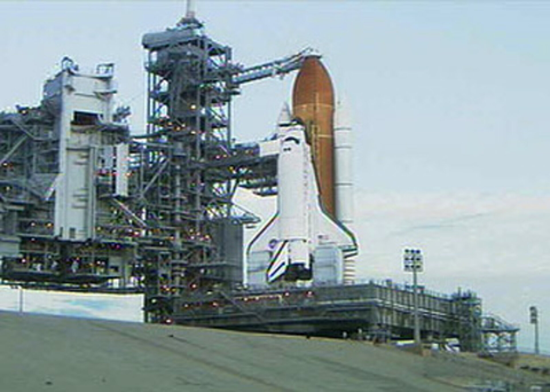 The rotating service structure on Launch Pad 39B is rolled back to reveal Space Shuttle Discovery