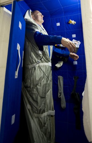 ESA astronaut Andre Kuipers tries out the Space Station bedroom mock-up at EAC