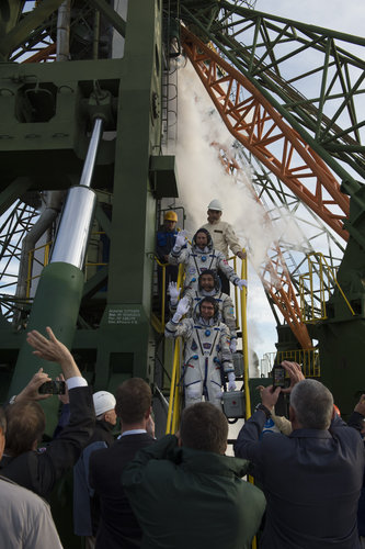 Soyuz TMA-18M crew members greeting audience at the launch pad