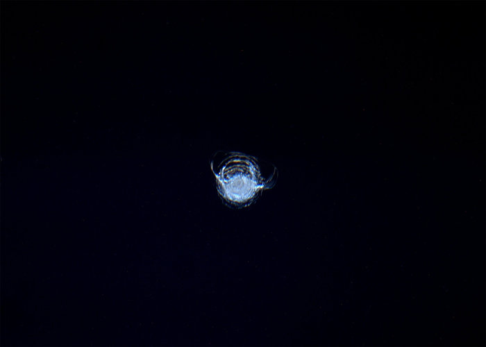 A debris impact chip in a Space Station window