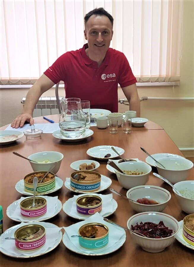 ESA astronaut Matthias Maurer tasting different russian space food items