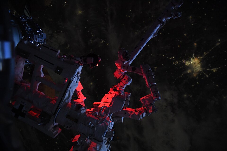 Space Station robotic arm at night 